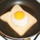 Starting to fry bread with duck egg in centre