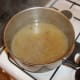 The remaining impurities are ready to be strained from the lamb stock