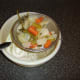 Straining the vegetable pieces from the stock.
