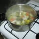 Water is added to the vegetables and herbs and brought to a simmer.
