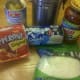 Ingredients to make pepperoni and pineapple mini pizzas.