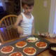 Sprinkle mozzarella cheese on top of pizza sauce.