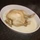 Poached chicken is removed from the pot