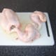 Leg and thighs are cut from the chicken