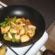 Sweet and sour sauce is added to chicken and vegetables