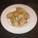 Cooked chicken portions are removed from stew pot