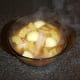 Heated chicken stock is poured in to the casserole dish