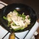 Chicken is added to stir fried vegetables to heat through