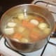 Chicken stock is added to the stew pot last of all