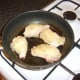 Chicken portions are browned in oil