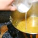 Once the vegetables and chicken are cooked, remove and add the flour/milk mixture to the broth. Stir to thicken (this makes a thin gravy). Serve with rice!