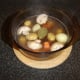 Lamb stock is poured in to casserole and it is ready for the oven
