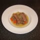 Beef casserole is plated and ready to be garnished