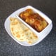 Naan bread is sliced and plated with the Jalfrezi chicken thighs