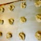 Uncooked batter dropped by the teaspoon onto a greased cookie sheet