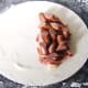 Place the sausage on top of the bacon