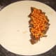 Beans are spooned on beef