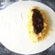 Pickle is spooned on to cheese and onion