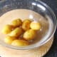 Roast potatoes are swirled in salt and garlic