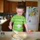 Spreading the pie filling helps develop fine motor skills, yet another way that cooking is a wonderful activity for kids!