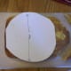 Use a 9 inch diameter circle to help you cut off the corners of the cake.