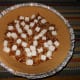 Spread the pecan pieces and marshmallows evenly across the bottom of the graham crust pie shell.