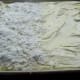 Cake in 16 x 11 cookie sheet with half of topping on sprinkled on.