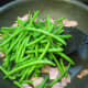 Step 5: Take the green beans out of the microwave, cut open the bag (be careful of the steam!) and then pour them into the pan with the Turkey Bacon..