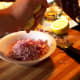 Squeeze the juice from one lemon over the onion.