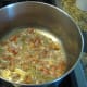 Chop the salt pork or bacon into small pieces, then brown lightly in your stock pot or Dutch oven.