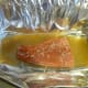 Lay trout fillet on the foil, skin-side down. Add some of the garlic bits and beer.