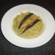Mackerel fillets are placed on the spaghetti