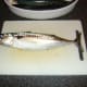 Mackerel is laid flat on a chopping board