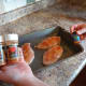 Sprinkle the seasoning on top of the chicken.