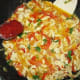 Mix fried meat with vegetables and add tomato paste