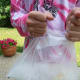 Grab the corners of the large bag and shake, moving hands up and down.