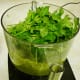 Filling the mixing bowl with the fresh ingredients for the pesto.