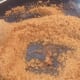 Sugar starts to melt. Add vanilla essence and keep stirring.