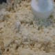 Crumbly mixture after processing - butter and dry ingredients.