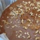 Toffee in pan, with walnuts sprinkled over it.