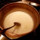 Mix together sugar, milk, and salt in large pot.
