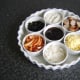 Ramekins are assembled on a serving tray or dish.