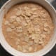 Now layer over the rest of the pudding mixture and then top with flaked almonds.