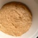 Spread half the mix inside an ovenproof dish. (This pudding rises more than version 1 so make sure to use a deep dish.)
