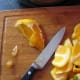 Peeling and chopping the orang flesh.