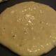 Cook the pancakes, flipping them when you see air bubbles popping.