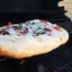 If the bottom is browning too fast, raise the pizza up to a higher grate or lower the flame.