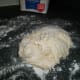Put the dough on a four-covered surface.