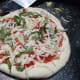 Pizza Margherita is ready to grill.