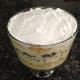 9. Spread Cool Whip topping over peaches.